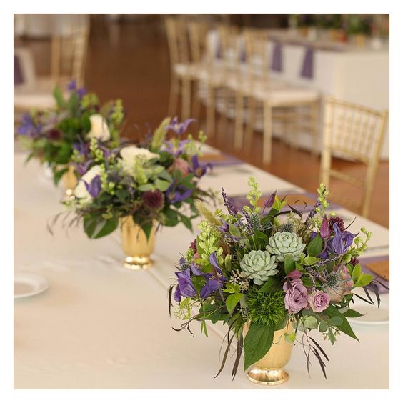 floral verde centerpieces in brass vases