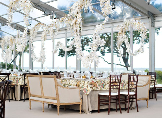 tent wedding reception with orchid garlands